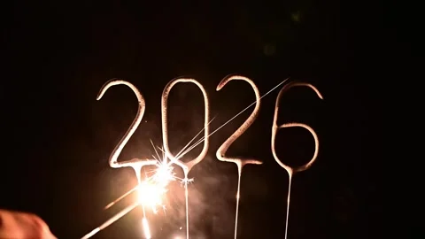 Burning sparkler digits forming 2026 glowing with sparks for festive New Year Stock Footage 316985518