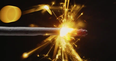 Burning sparkler firework with hot glowing embers on black background Video stock 317530253