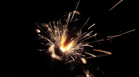 Burning sparkler in front of a dark background Stock Footage 45577495
