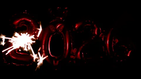 A burning sparkler is ignited with a lighter and waved from side to side in.. Stock Footage 322089005