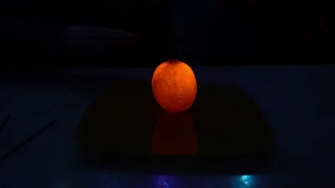 A burning sparkler inside a glowing lemon. 動画素材 237740016