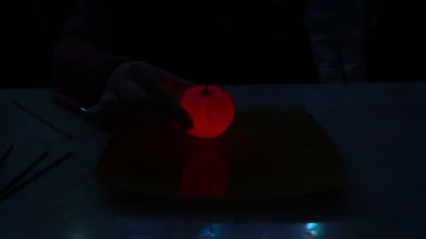 A burning sparkler inside a glowing mandarin Video stock 237710990