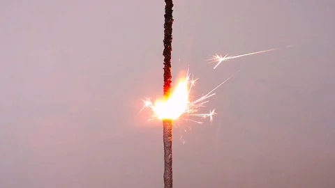 Burning sparkler, white background. Stock Footage 103857811