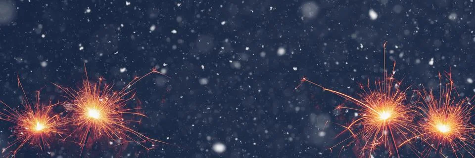 Burning sparklers on abstract snowy background, party concept with advertisin Illustrazione stock