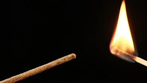 Burning stick with incense on a black background  Stock Footage 136828494