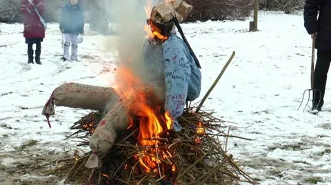 Burning a straw doll on a funeral pyre for driving out the winter Stock Footage