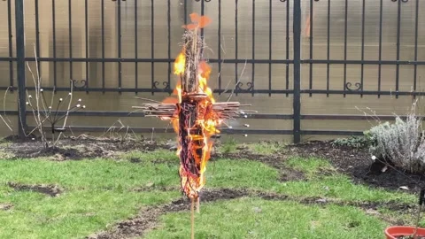 Burning Straw Effigy in Field Concept of Purification and Rebirth Stock-Footage 320949667