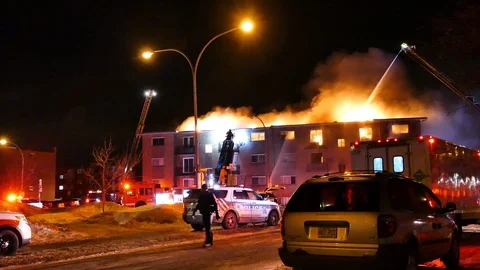 Burning structure and tired firefighter Stock Footage 105295718