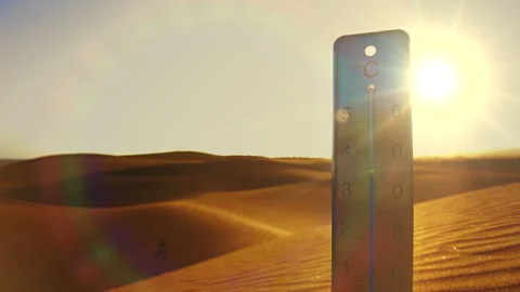 A burning sun shines on a thermometer stuck in the sand of a dune. Stock Footage 264801376