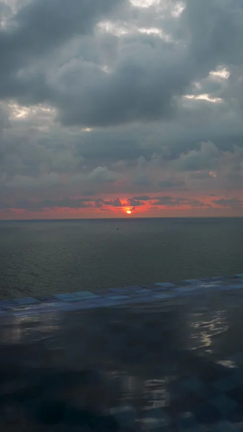 Burning sunset reflecting on calm ocean water Stock Footage 309106638