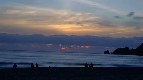 Burning Sunset Timelapse on ocean sea coast with people fishing and sky motion Stock Footage 109305422