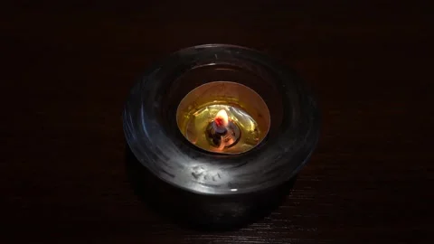 Burning tea candle with beeswax Stock Footage 221171237