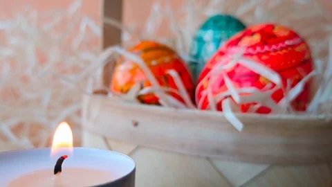 Burning tea light candle and easter basket Stock Footage 104654320
