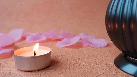 Burning tea light candle, rose petals and pomander Stock Footage 103857464