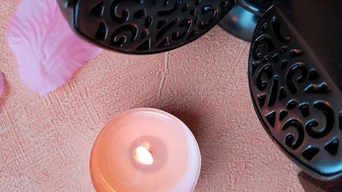 Burning tea light candle, rose petals and pomander Stock Footage 103857466