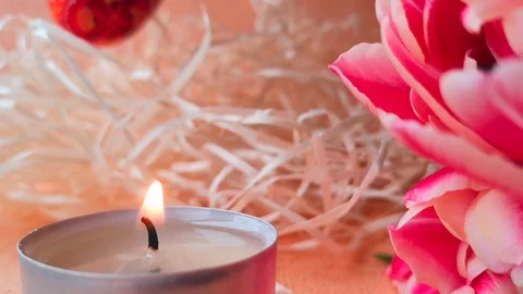 Burning tea light candle, tulips and Easter eggs Stock Footage 104106071
