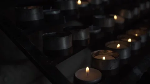 Burning tea light candles in old church. Slow motion camera. Stock Footage 170515987