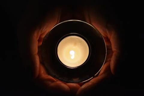 Burning tealight in cupping hands Stock Photos