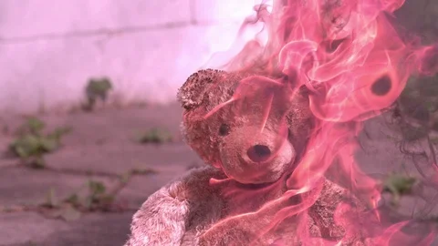 Burning Teddy bear in slow motion Stock Footage 92221566