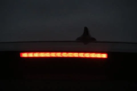 Burning third brake light diode stripe of a modern sport crossover Stock-Fotos