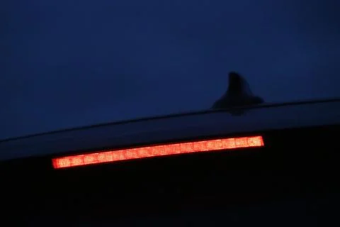Burning third brake light diode stripe of a modern sport crossover Stock Photos