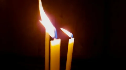 Burning of three candles on a black background Stock Footage 85436153