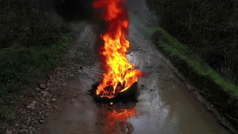 Burning tires on the road Stock Footage 170773215