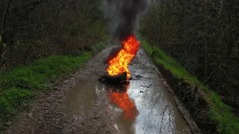 Burning tires on the road Stock Footage 170773286