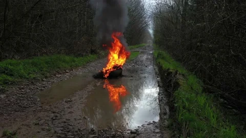 Burning tires on the road Stock Footage 170773355