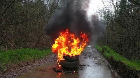 Burning tires on the road Stock Footage 170773694