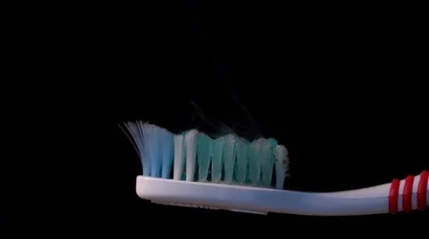 Burning toothbrush on black Stock Footage 36437143