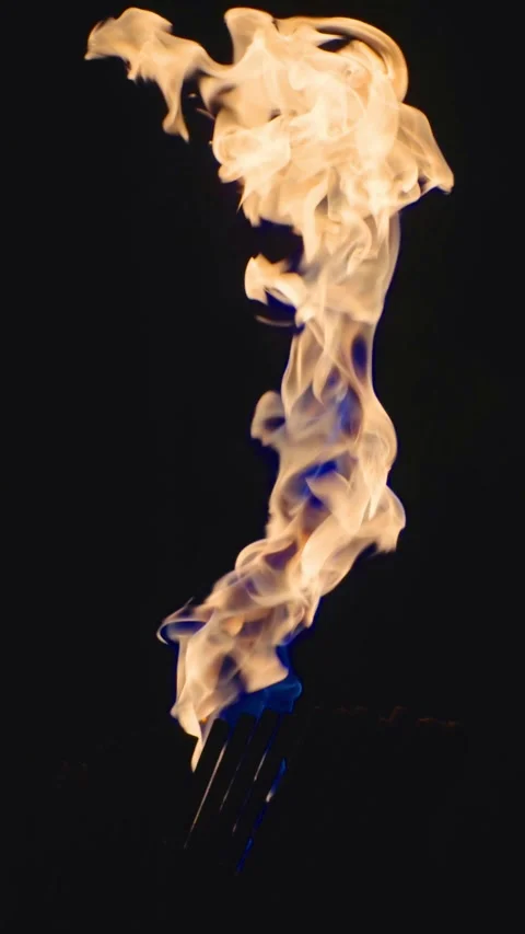 Burning torch emitting bright flames against the backdrop of a rock wall Stock Footage 311183068