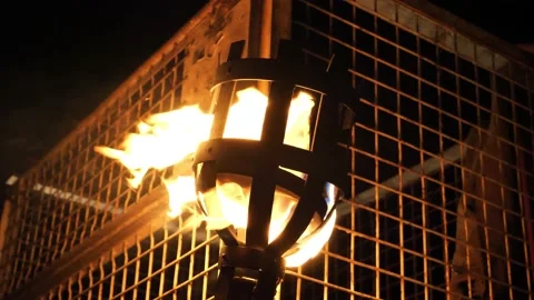 A burning torch in the night Stockbeeldmateriaal 141204242