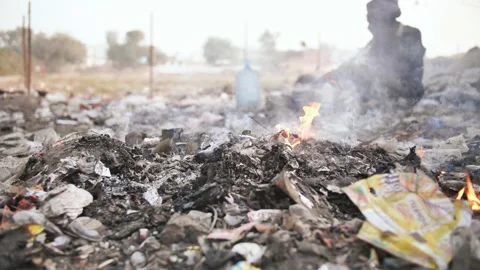 Burning trash and poor Indian old man. Stock Footage 105038519