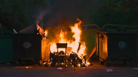 Burning trash container and old wood chair with other garbage. Plastic garbage Video stock 117071545