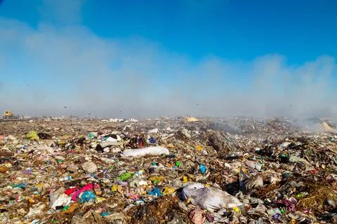 Burning trash piles in landfill Stock Photos