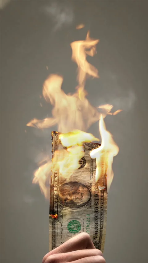 Burning US Dollar Bill Held by Hand Video stock 303142994