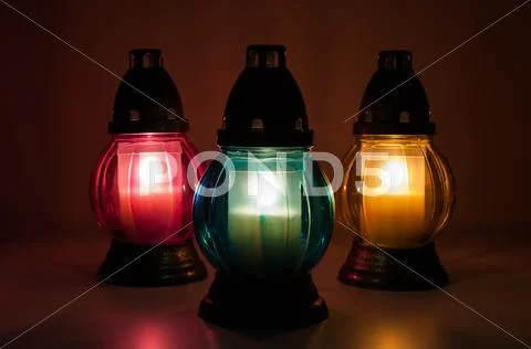 Burning votive candles in the dark Stock Photos