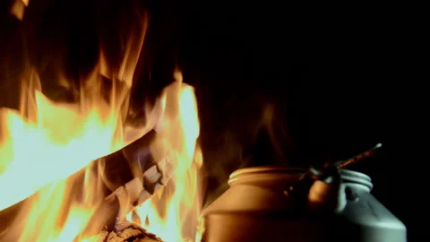 Burning warm bonfire. With a defocused coffee pot in the foreground. Stock Footage 141467526