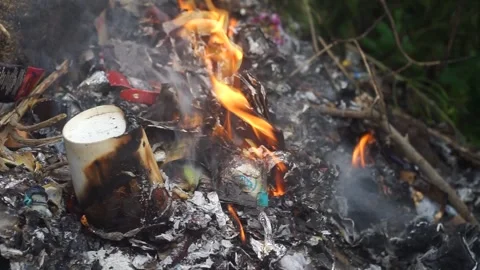 Burning waste that is a mixture of plastic and paper Stock Footage 295472381
