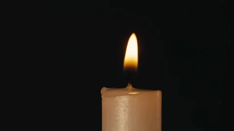 Burning wax candle on black chroma key background. Fire flame candlelight close Stock Footage 197857306