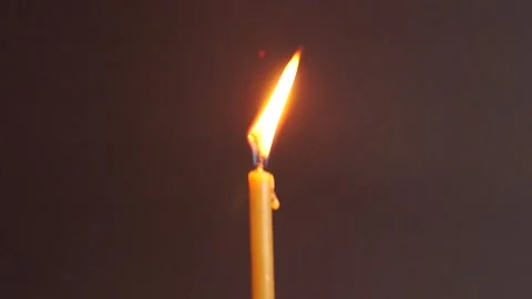 Burning wax candle close up on dark background Stock Footage 145161260