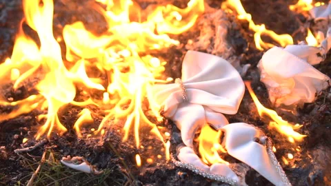 Burning white bow tie on ground Stock Footage 96085796