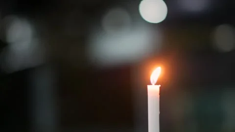 Burning White Candle with a Soft Bokeh Background Stock Footage 346133126