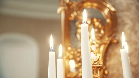 Burning white candles in classic interior with candlestick and mirror Video stock 99560879