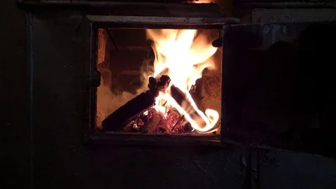 Burning wood and coals inside old stove Stock Footage