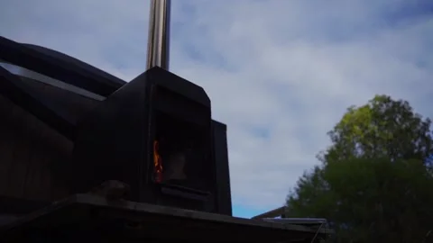 Burning wood fire in a rusty old metal wood stove Video stock 218345104