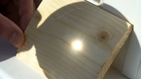 Burning on the wood pattern . with the help of magnifying glass burns on a Stock Footage 77848090