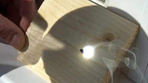 Burning on the wood pattern . with the help of magnifying glass burns on a Stock Footage 77848273