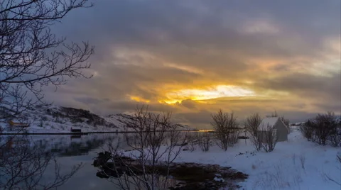 Burning Yellow Sky Above Small Cabin and Fjord In Winter , Static Timelapse Stock Footage 61070573